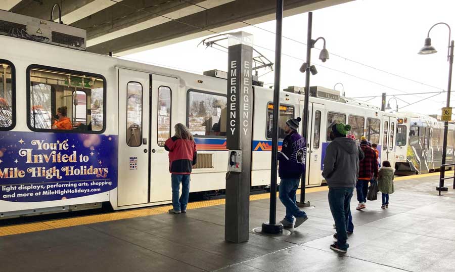 View of people waiting to get in the light rail in Denver