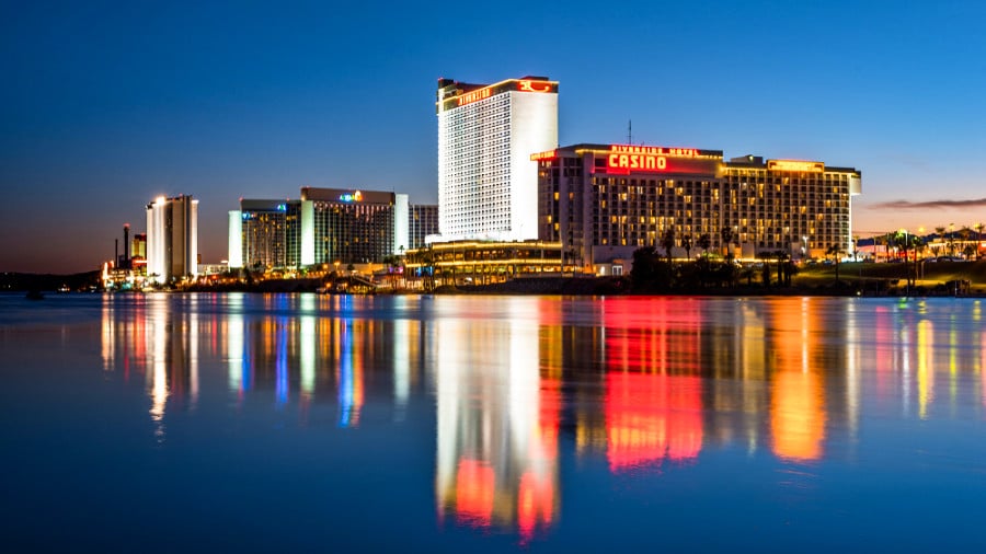 Illuminated lights of the Laughlin hotels and casino reflected on The Colorado River