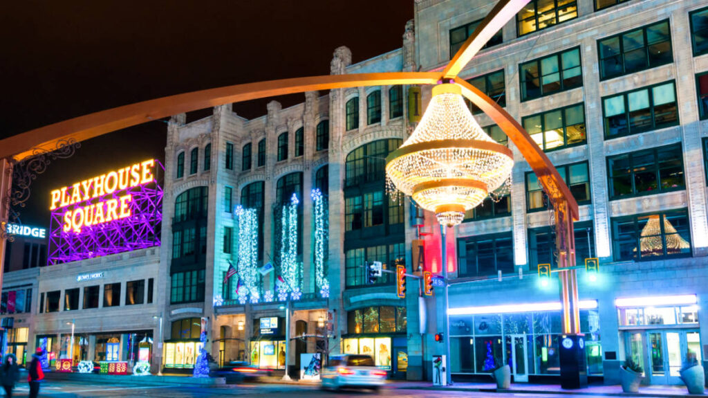 View of the illuminated signage of Playhouse Square and the giant chandelier above Euclid Avenue at night