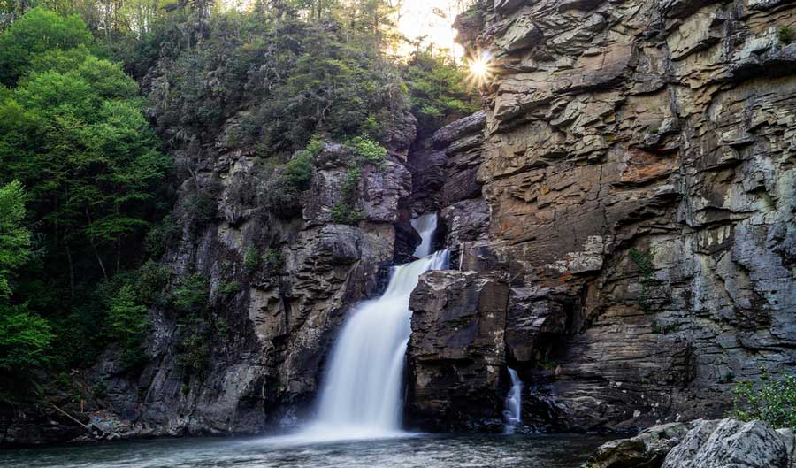 The cascading water of Linville Falls on the rocky mountain