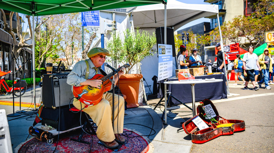 View of a musician performing in Little Italy