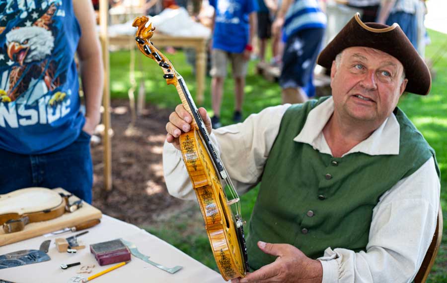 A man holding a violin during the Living Traditions Festival