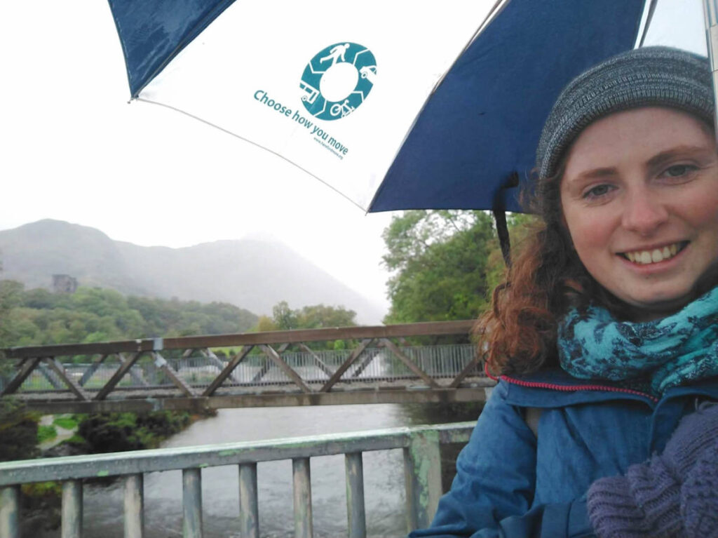 The author, Ruthie Walters holding an umbrella while raining in Llanberis