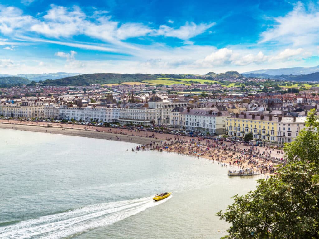 Panoramic view of the town of Llandudno and the speedboat on the water