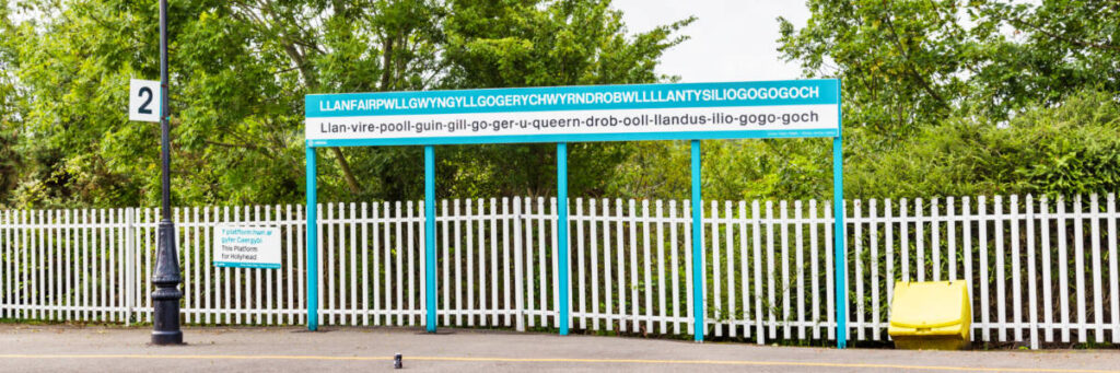 View of the train station signage of Llanfairpwllgwyngyllgogerychwyrndrobwllllantysiliogogogoch on the street
