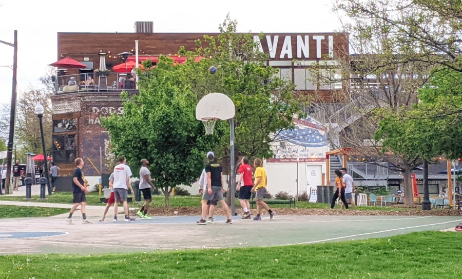 A basketball court in front of Avanti Food and Beverage in Lower Highlands
