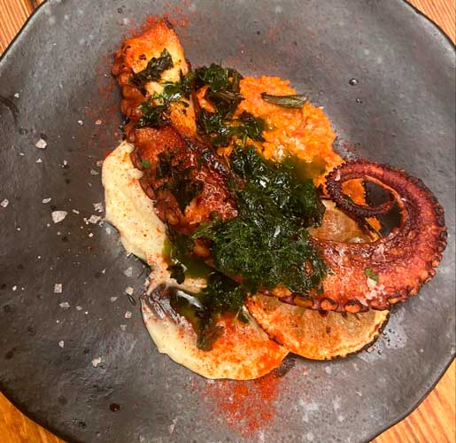 An octopus dish on a plate in Lobos Meat and Tapas