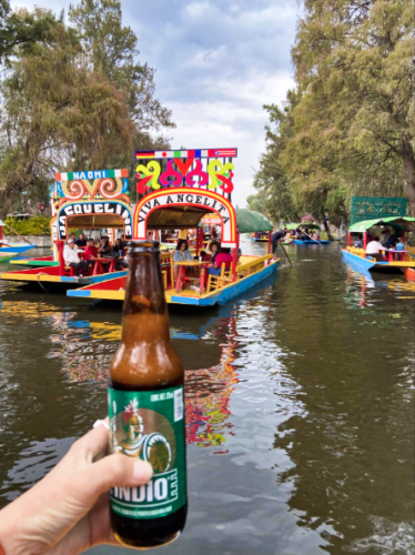A bottle of local cerveza on the floating canals of Xochimilco