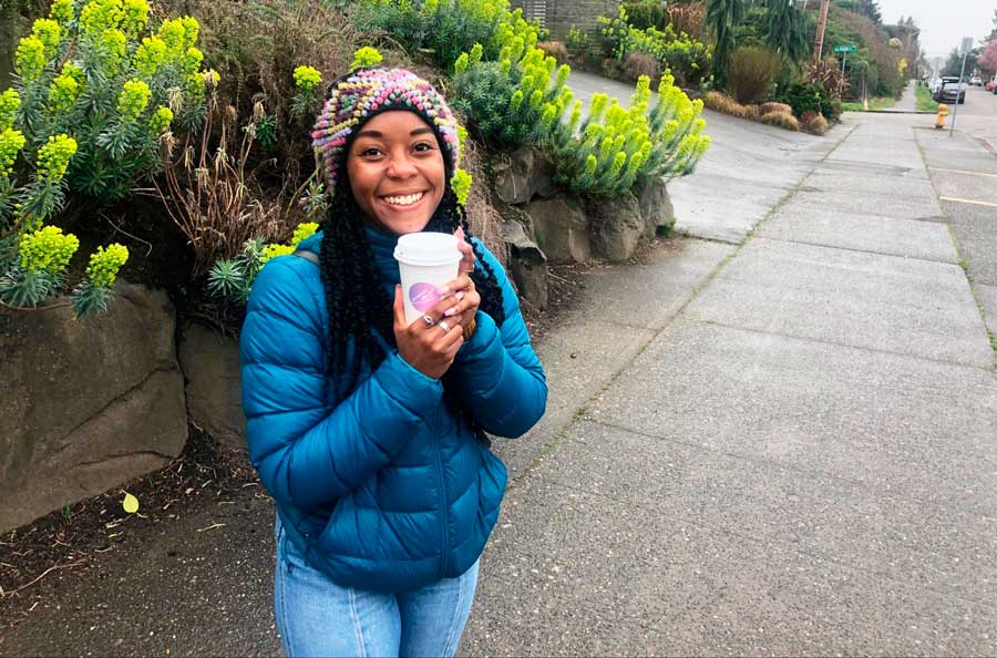 The author holding a cup of coffee from a local shop in Seattle