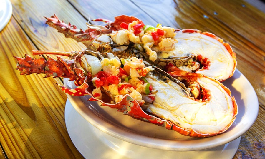 A cooked lobster sliced in half on a plate