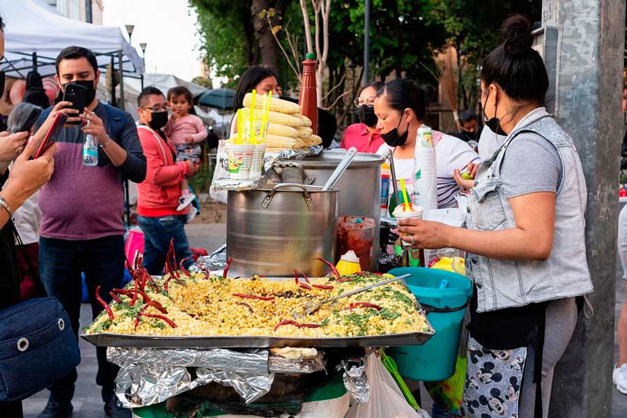 People buying from a local food stand in Mexico City