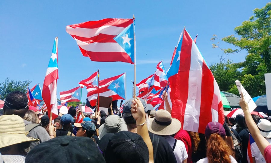 View of locals raising the Puerto Rico flags