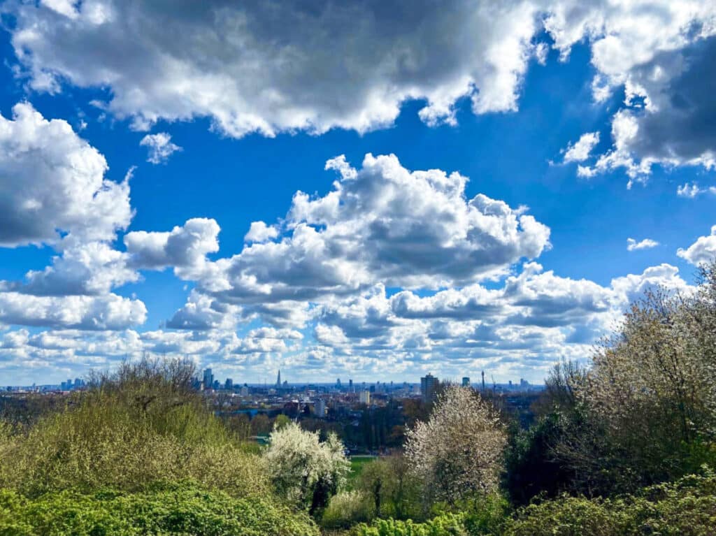 Overlooking view of the cityscape of London and the blue sky from Hampstead Heath