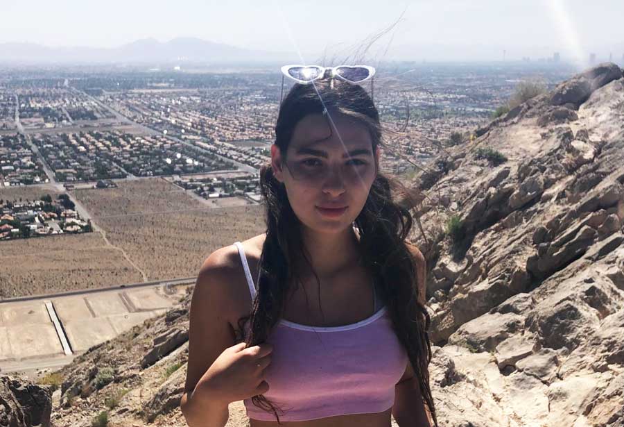 The author, Isabelle Pavese, at the top of Lone Mountain Loop Trail with an overlooking view from it