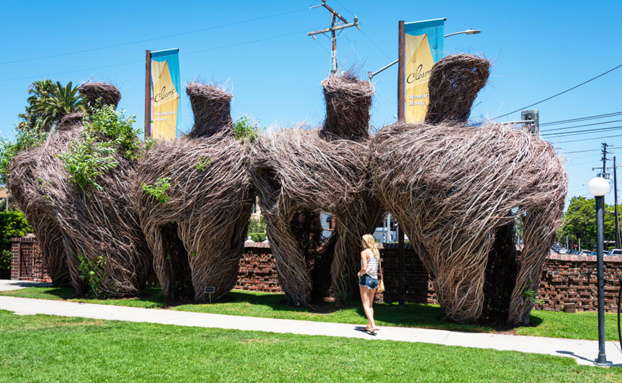 A woman walking around Long Beach Museum of Art