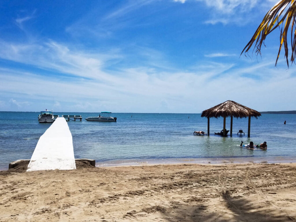 View of the long boardwalk and the hut on the beach of Copamarina Beach Resort
