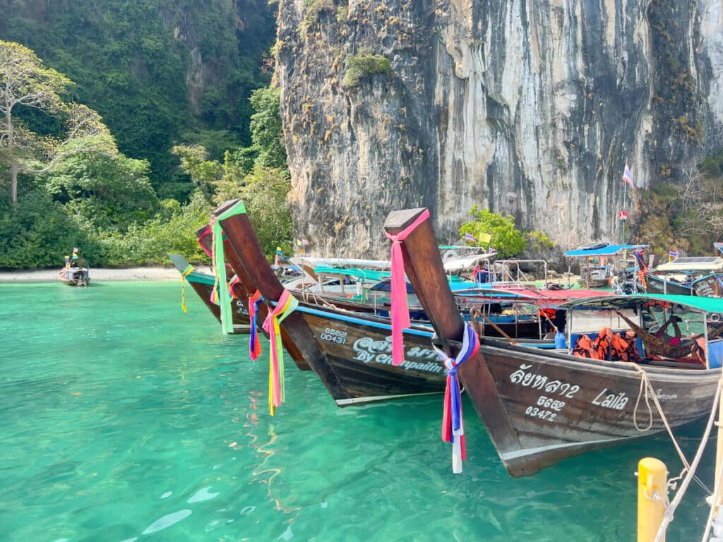 Longtail boats floating in turquoise water on Hong Island