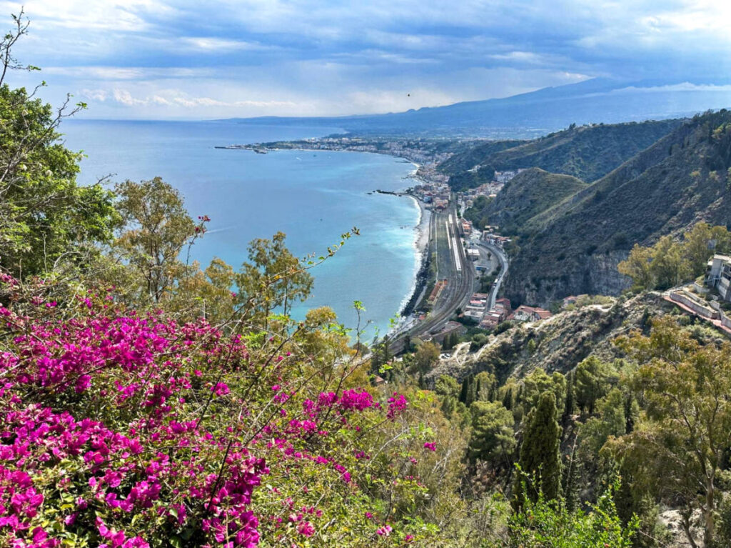 View of the blooming flowers and the scenic lookout point in Taormina, Sicily