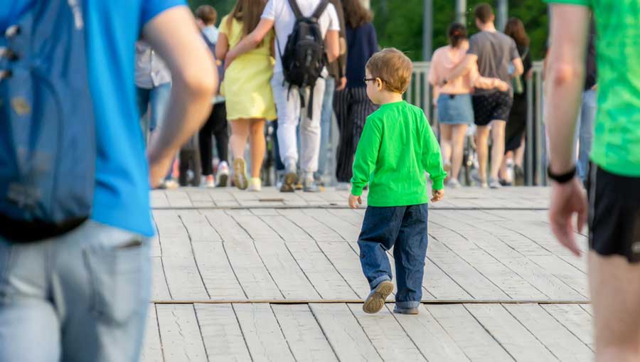 View of a little boy getting lost in a park