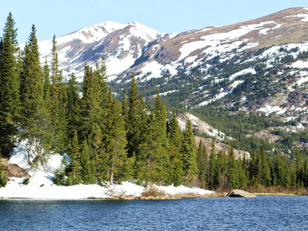 Scenic view of the Lost Lake and the snowy Rocky Mountains