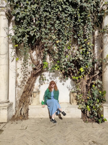 Louise Wylie sitting and smiling for a photo in Seville, Spain