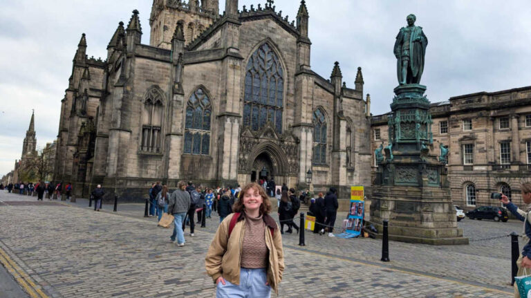 The author Louise Wylie, posing for a photo in front of St Giles’ Cathedral