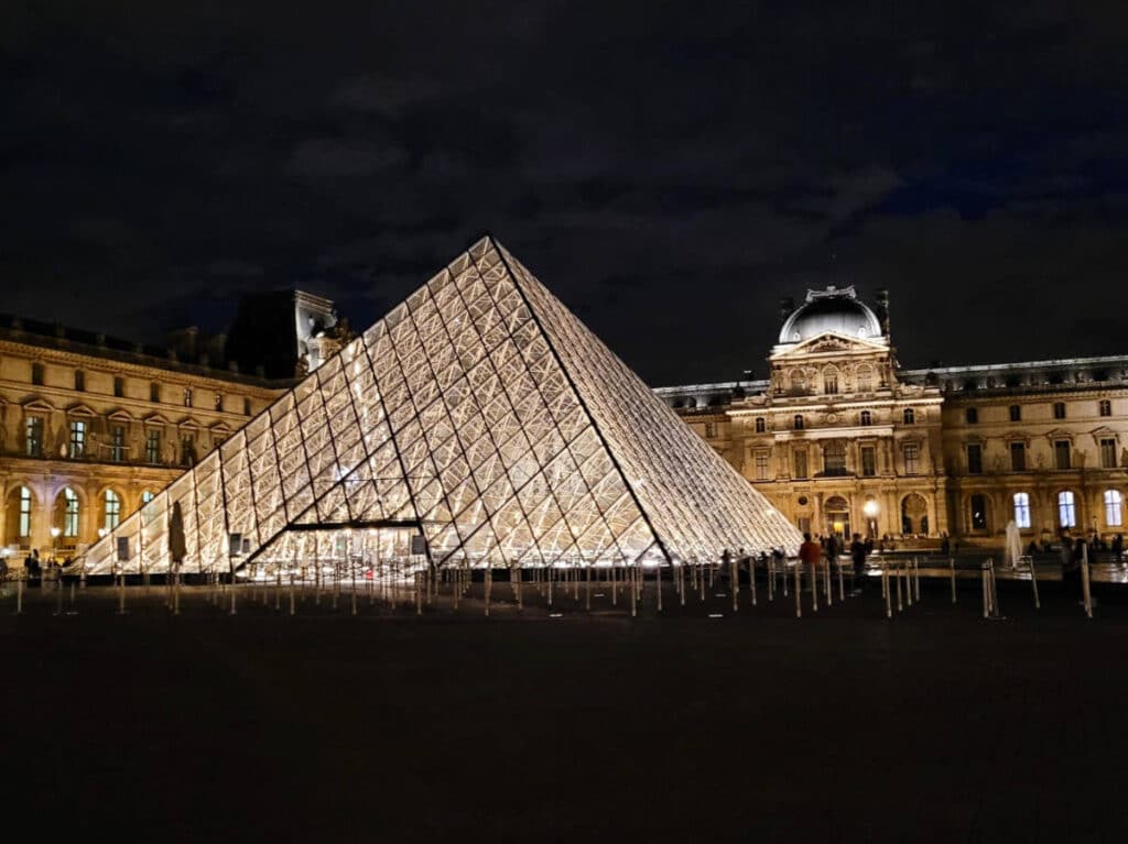 View of the Louvre Pyramid in Paris at night