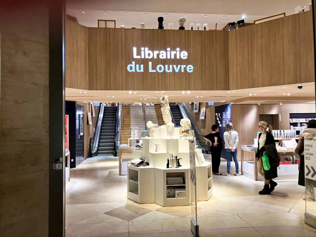 The people wandering inside the Louvre’s Bookshop seen from the entrance