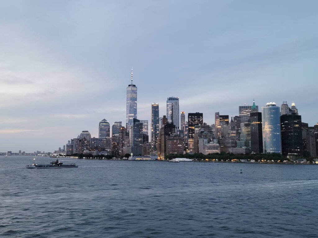 Panoramic view of the Lower Manhattan from the ferry at dusk