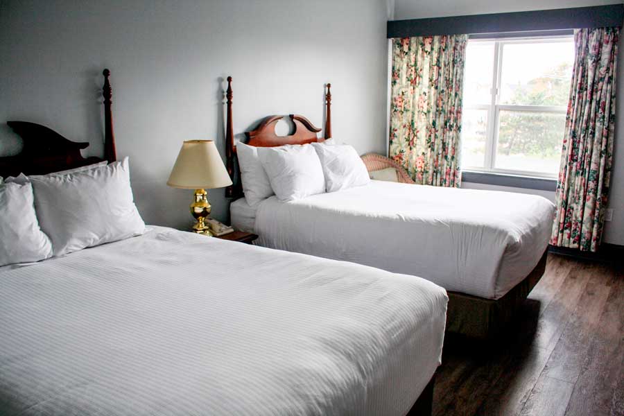 View of single beds inside a room in Loyalist Country Inn