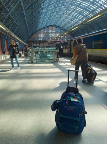 A blue suitcase on the ground at St Pancras International