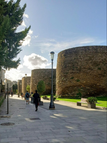 People walking near Lugo’s historic walls