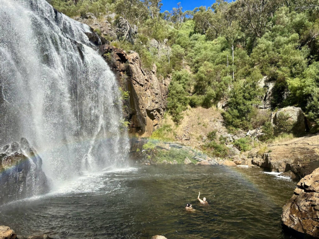 Friends swimming at the base of MacKenzie Falls