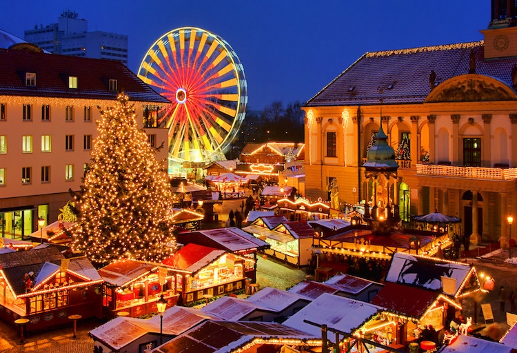 View of the festive Magdeburg Christmas market at night, with ferris wheel and Christmas tree