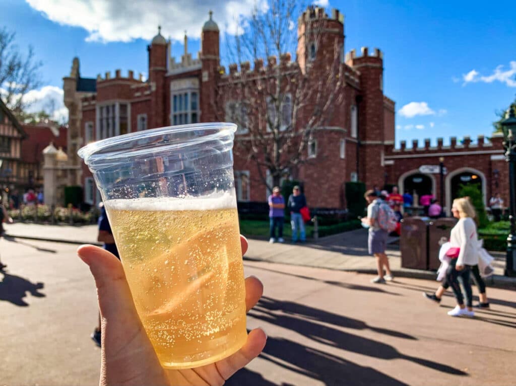 A hand holding a cup of Magners pear cider in the UK Pavilion