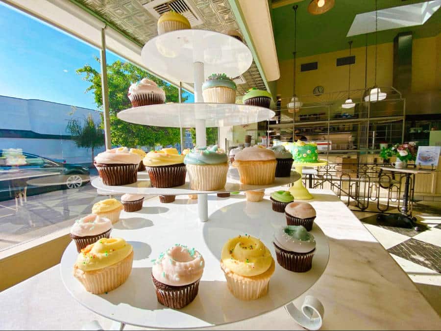 Spring colored cupcakes displayed on a cupcake tier at Magnolia Bakery