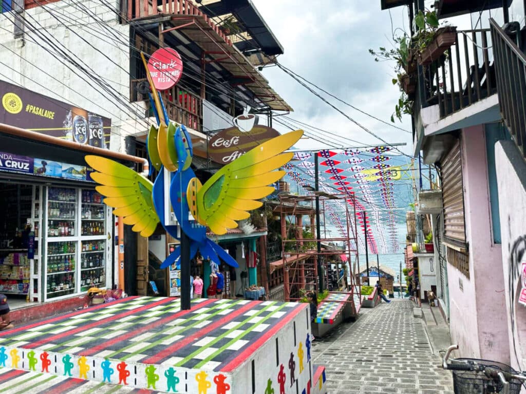 View of the bird sculpture at the colorful main street in San Pedro La Laguna