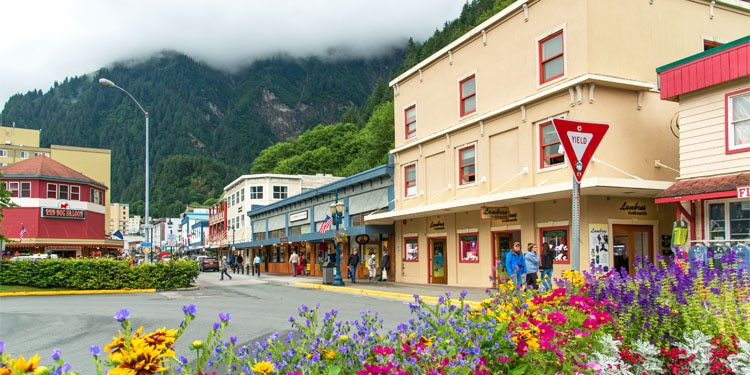 View of Main Street in Juneau, featuring colorful flowers and buildings in the background