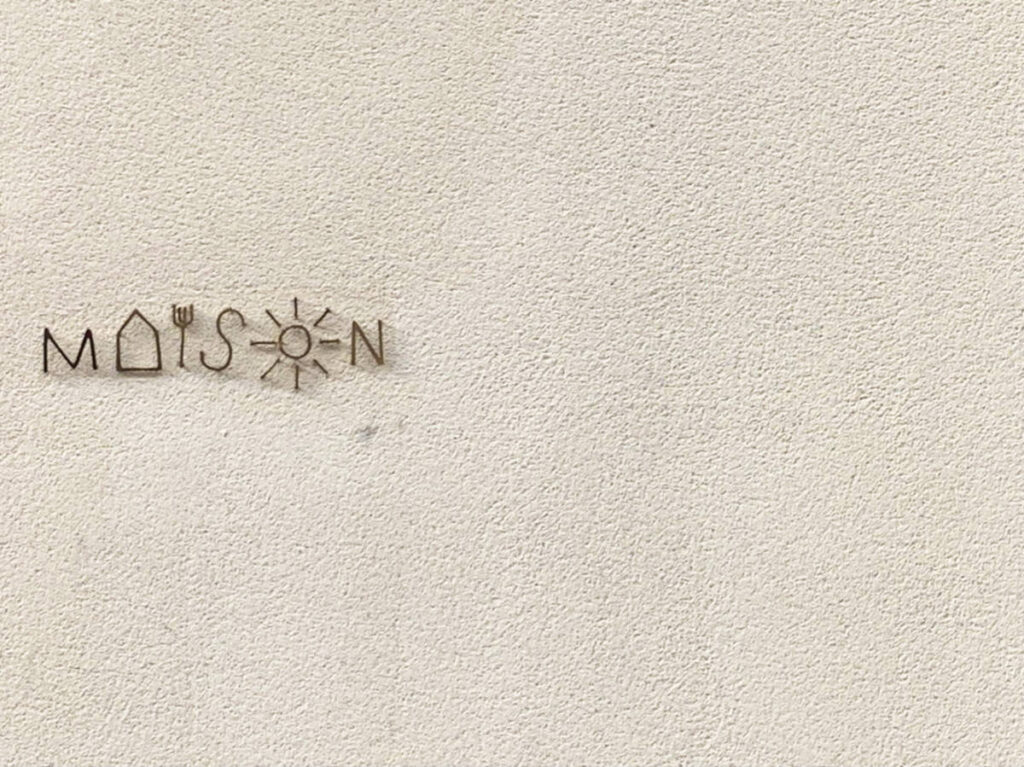Logo of Maison outside the restaurant