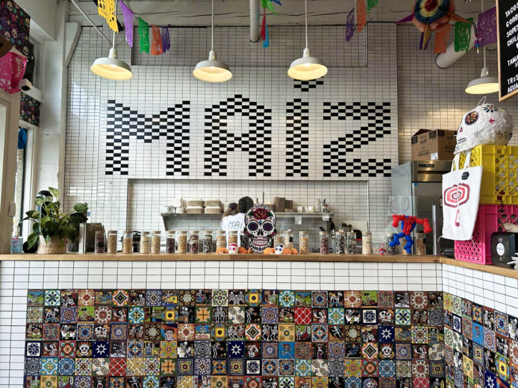 View of the interior with colorful tiled walls of Maíz