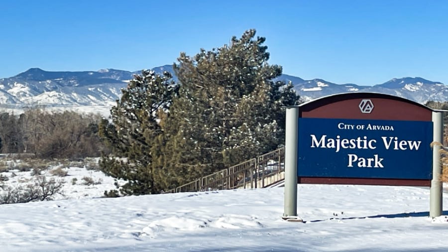 View of the signage of Majestic View Nature Center with the snow covered mountains in the background