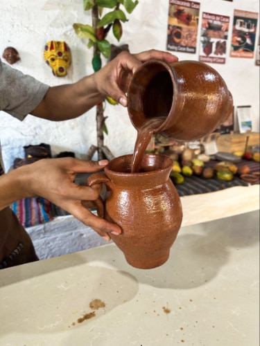 Closeup view of making the Mayan chocolate drink using the traditional pots