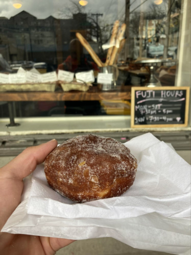 Holding a Malasada from Fuji Bakery