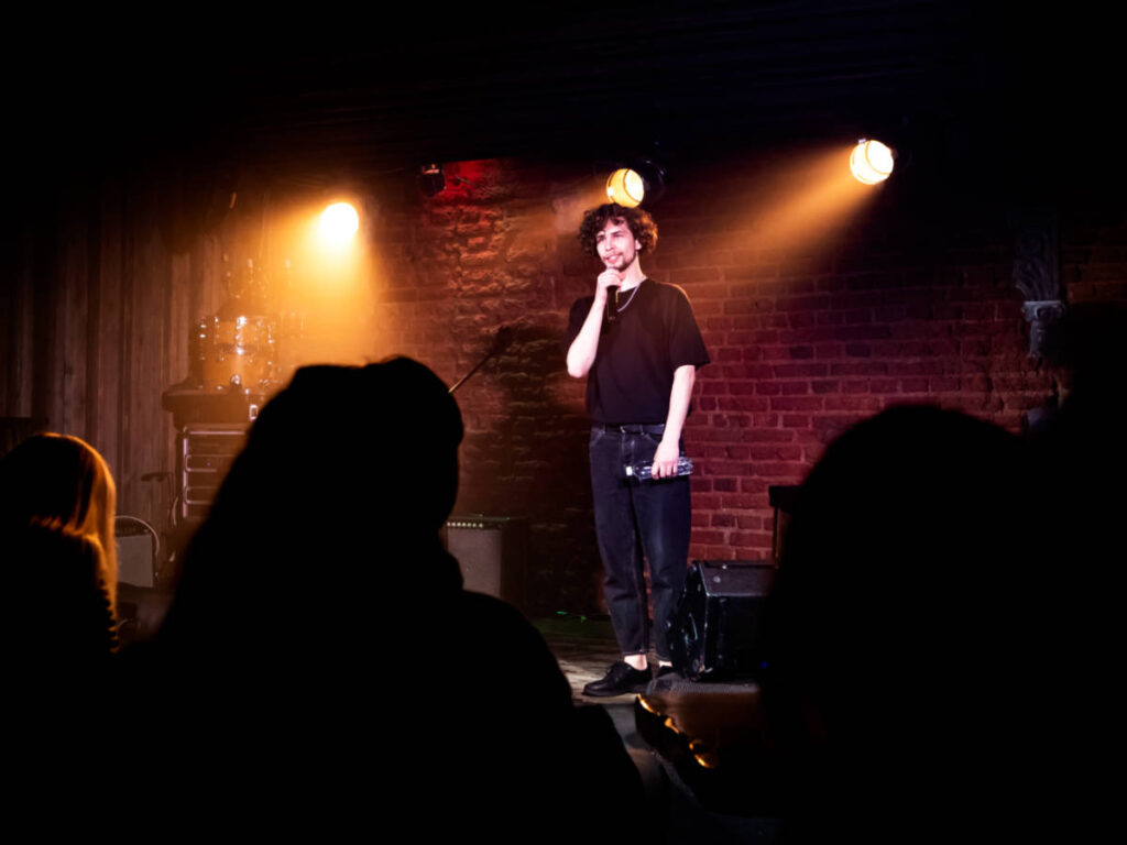 A male comedian performing on stage