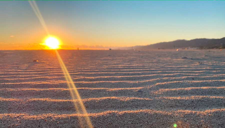 View of the sunset over the sand in Malibu Beach