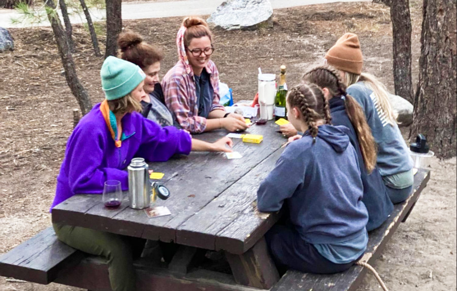 A group of friends playing cards at the camping site in Mammoth Lakes