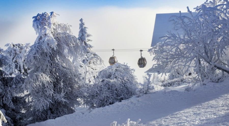 Two gondola rides at a snow covered ski area in Mammoth Mountain