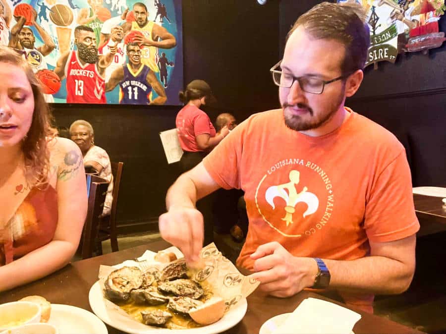 The author's friends enjoying the chargrilled oysters from Neyow’s in Mid-City