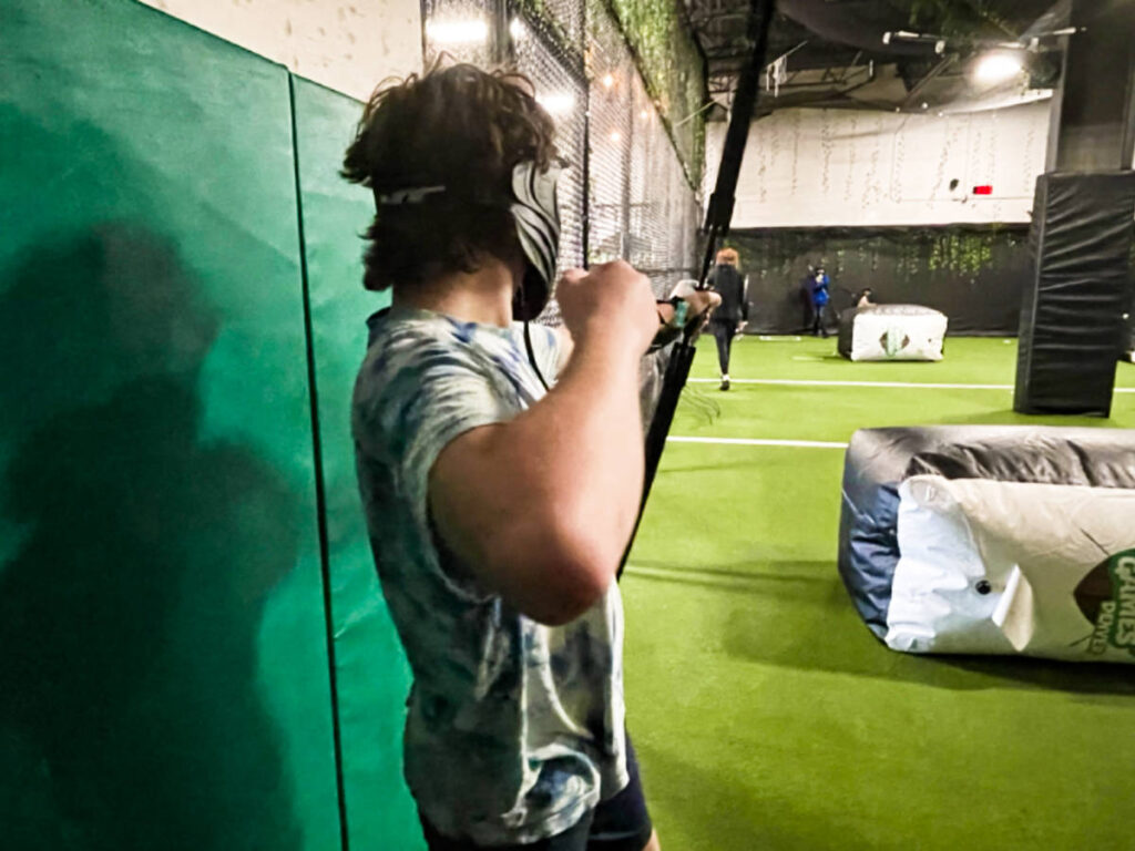 A man practicing archery indoor