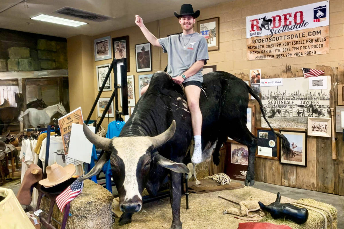 A man riding a bull at the Scottsdale Rodeo Museum